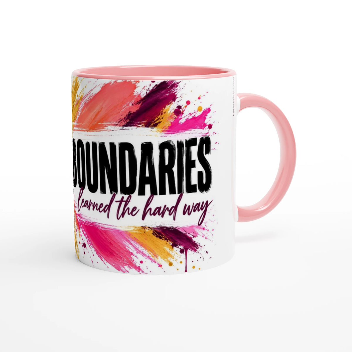 Boundaries 11 oz ceramic mug with a pink handle and splashes of pink, orange and plum paint, handle on the right