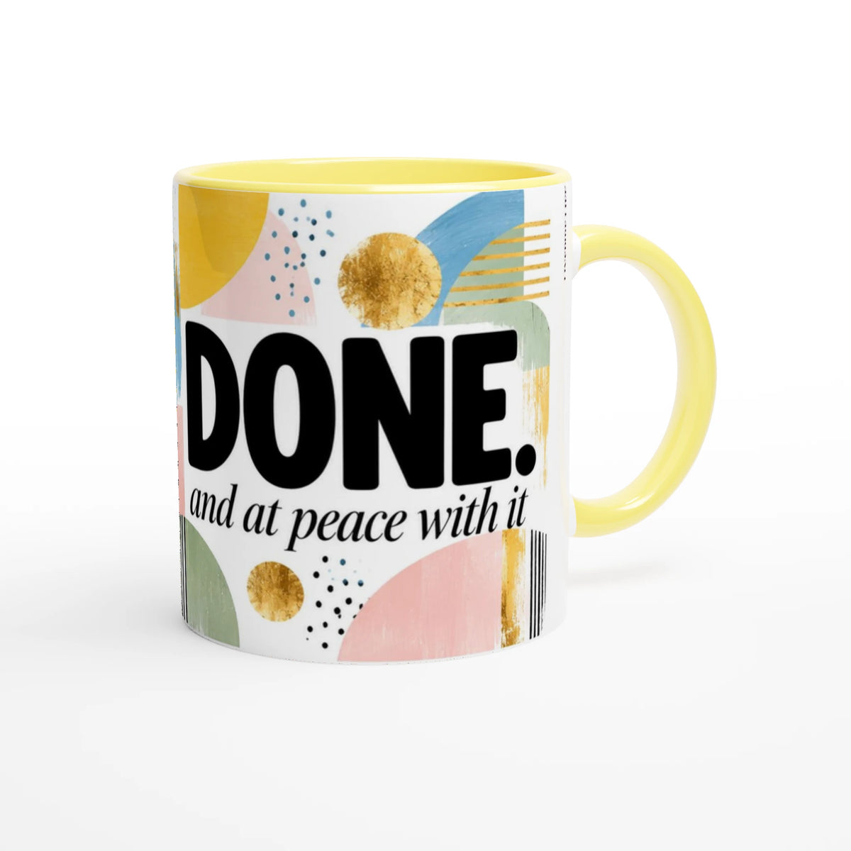 Done and at Peace 11 oz ceramic mug with a yellow handle and mustard and sky blue geometric shapes, handle on the right