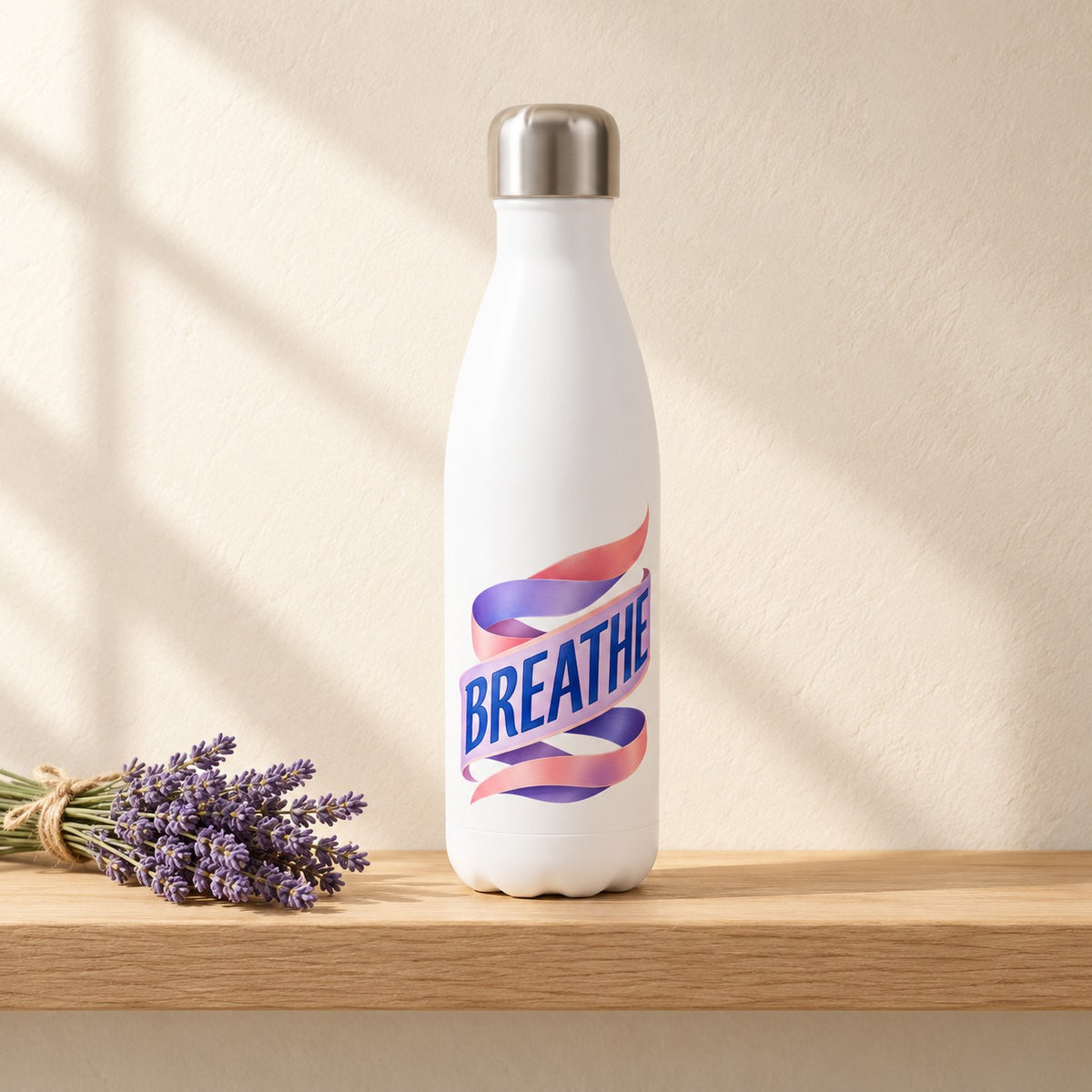 Breathe white 17 oz water bottle with a pink and lavender ribbon around the word BREATHE, standing on a light oak shelf beside a lavender bundle