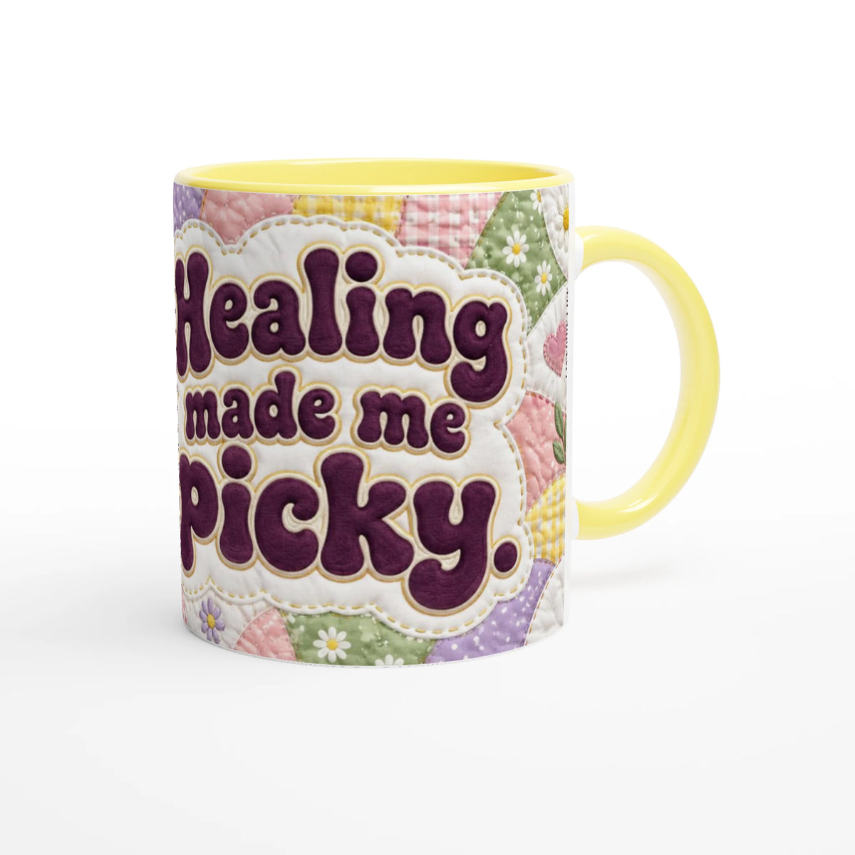 Healing Made Me Picky 11 oz ceramic mug with a yellow handle and a pastel patchwork quilt, handle on the right