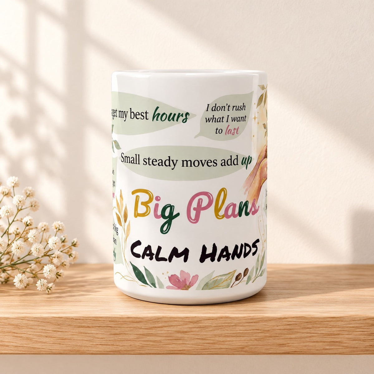 Big Plans Calm Hands 15 oz white ceramic mug resting on a light oak shelf against a warm cream wall